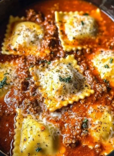 Crockpot Ravioli Lasagna in a slow cooker with layers of pasta and cheese