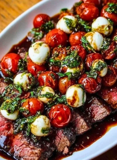 Grilled Flank Steak Caprese with fresh basil and balsamic glaze on a plate