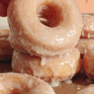 Homemade glazed donuts freshly made with a shiny, sweet glaze on top.