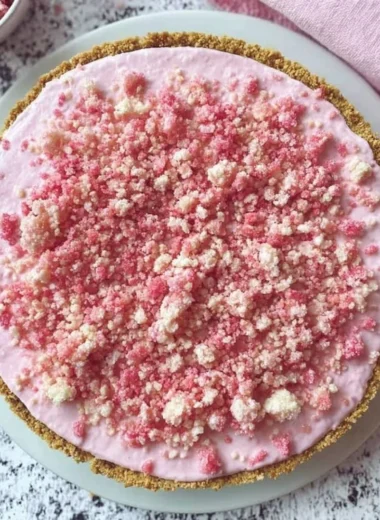 Delicious homemade strawberry ice cream pie with fresh strawberries and creamy filling.