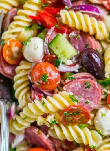 Delicious Italian pasta salad with cherry tomatoes, olives, and fresh basil