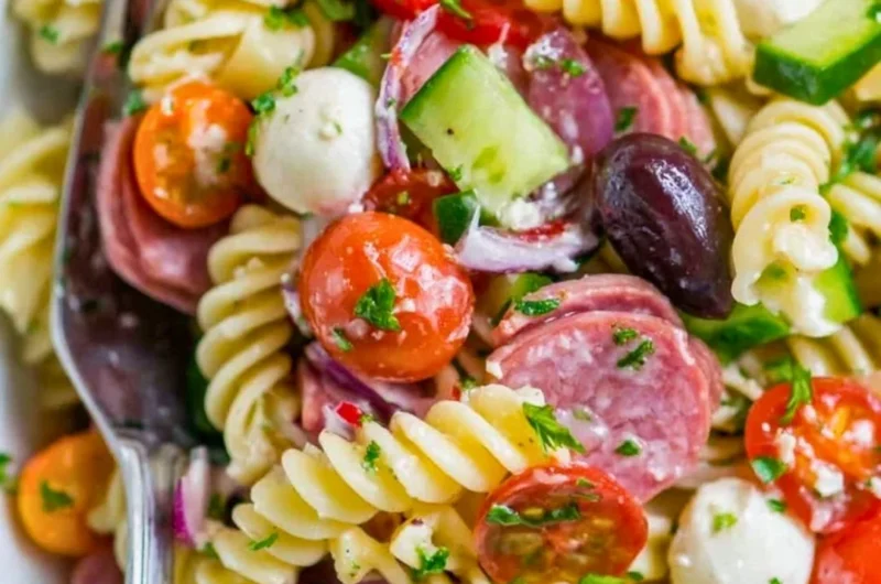 Delicious Italian pasta salad with cherry tomatoes, olives, and fresh basil