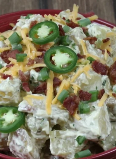 Jalapeño popper potato salad with creamy dressing and garnished with jalapeños.