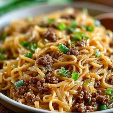 Delicious bowl of Mongolian ground beef noodles garnished with vegetables