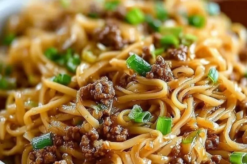 Delicious bowl of Mongolian ground beef noodles garnished with vegetables