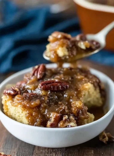 Delicious Pecan Pie Pudding Cake with pecans and caramel topping.