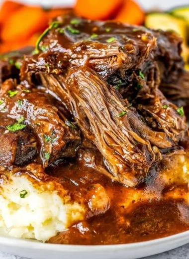 Delicious slow cooker short ribs served with vegetables on a plate.