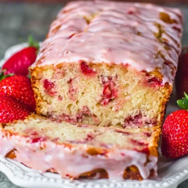 Freshly baked strawberry bread with slices showcasing its soft texture and juicy strawberries