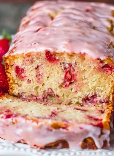Freshly baked strawberry bread with slices showcasing its soft texture and juicy strawberries