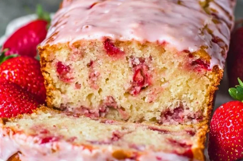 Freshly baked strawberry bread with slices showcasing its soft texture and juicy strawberries