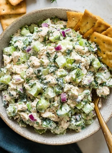 Delicious Tzatziki Chicken Salad served in a bowl with fresh herbs and vegetables.