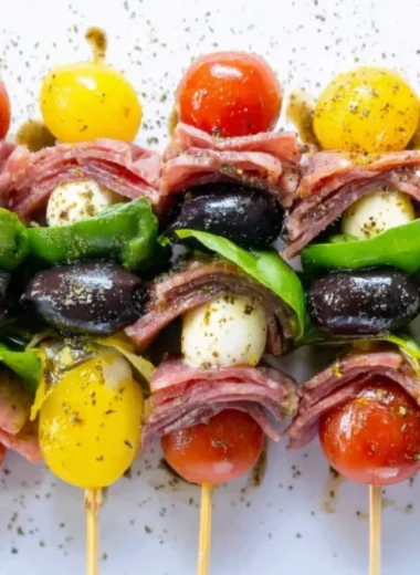 A platter of vibrant antipasto skewers featuring olives, cheeses, and vegetables.