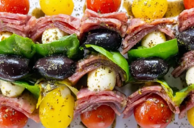 A platter of vibrant antipasto skewers featuring olives, cheeses, and vegetables.