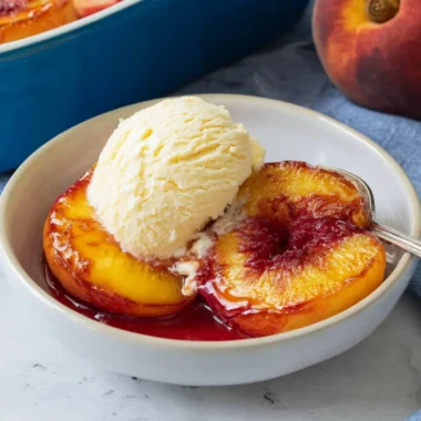 Deliciously baked peaches topped with cinnamon and served warm.