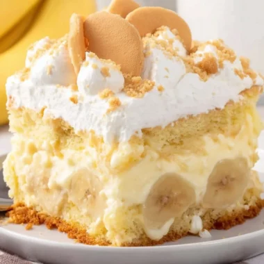 Delicious banana pudding cake layered with creamy banana pudding and whipped cream