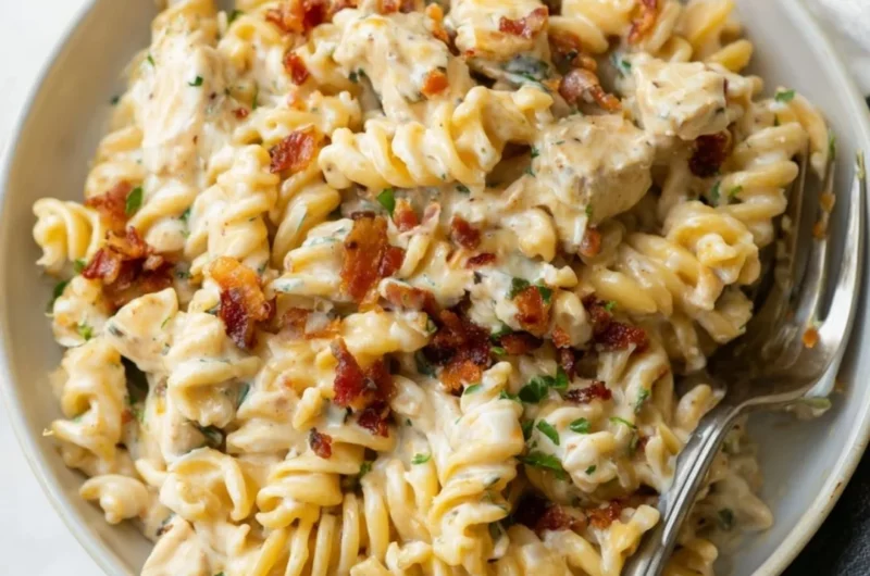 Creamy Chicken Bacon Ranch Pasta topped with fresh herbs and cheese