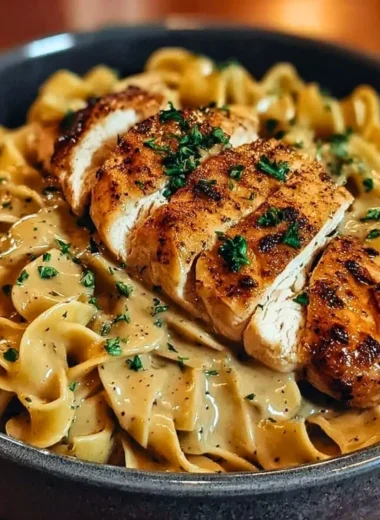 Plate of Chicken with Buttered Noodles garnished with herbs