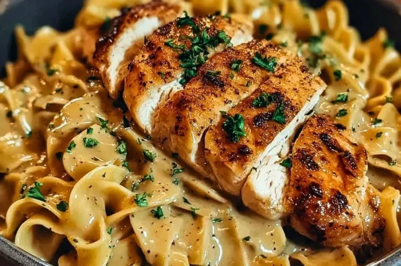 Plate of Chicken with Buttered Noodles garnished with herbs
