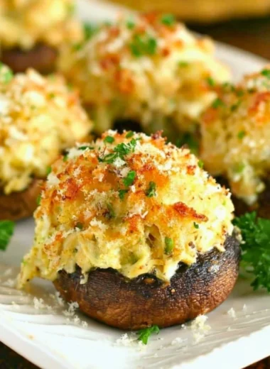 Delicious crab stuffed mushrooms topped with seasoning and garnished with parsley