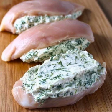 Cream cheese and herb stuffed chicken dish on a plate