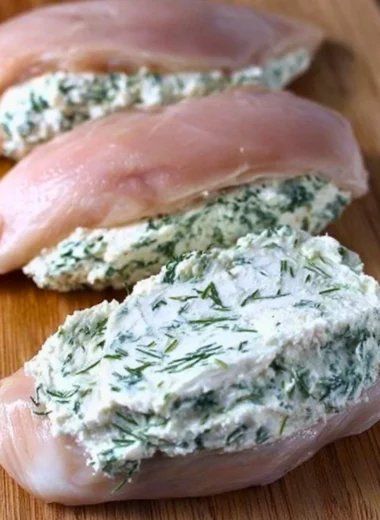 Cream cheese and herb stuffed chicken dish on a plate
