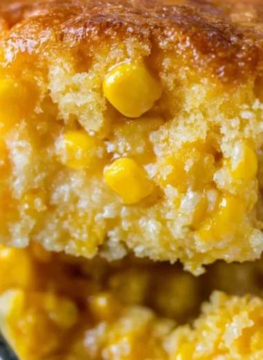 Delicious creamed corn casserole topped with golden brown corn and cheese.