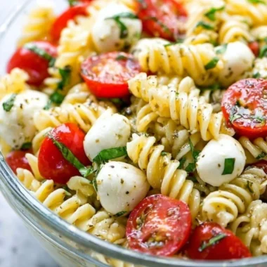 Creamy Caprese Pasta Salad featuring fresh tomatoes, mozzarella, and basil.