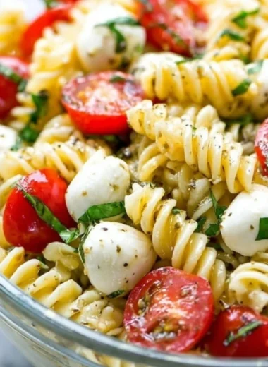 Creamy Caprese Pasta Salad featuring fresh tomatoes, mozzarella, and basil.
