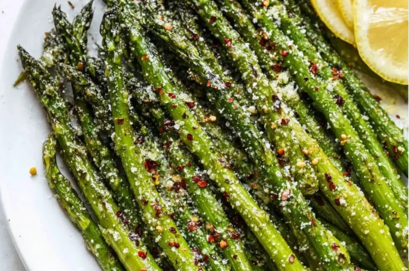 Delicious oven roasted asparagus with Parmesan cheese on a serving plate