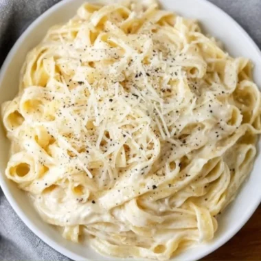 Delicious bowl of Fettucine Alfredo with creamy sauce and parsley garnish