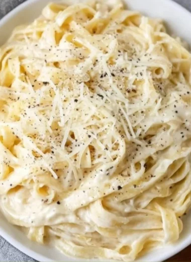 Delicious bowl of Fettucine Alfredo with creamy sauce and parsley garnish
