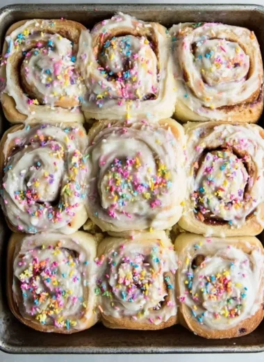 Delicious Funfetti cinnamon rolls topped with colorful sprinkles and icing