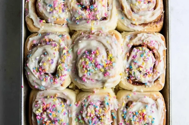 Delicious Funfetti cinnamon rolls topped with colorful sprinkles and icing