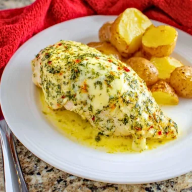Delicious Garlic Butter Chicken served on a plate with herbs and spices
