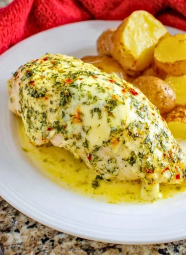 Delicious Garlic Butter Chicken served on a plate with herbs and spices