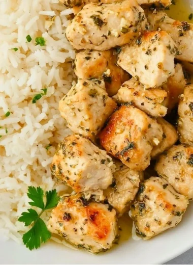 Plate of crispy Garlic Chicken Bites garnished with herbs