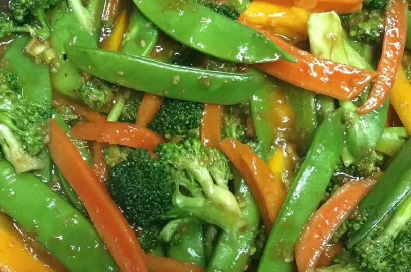 Colorful bowl of Ginger Veggie Stir-Fry with assorted vegetables and ginger
