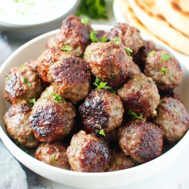 Homemade Greek meatballs served with tzatziki sauce and herbs