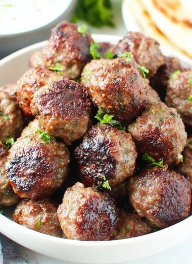 Homemade Greek meatballs served with tzatziki sauce and herbs
