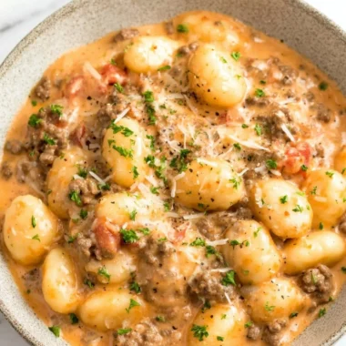 Plate of Ground Beef Gnocchi topped with parsley and cheese