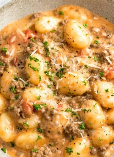 Plate of Ground Beef Gnocchi topped with parsley and cheese