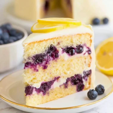 Delicious lemon blueberry cake topped with fresh blueberries and lemon zest