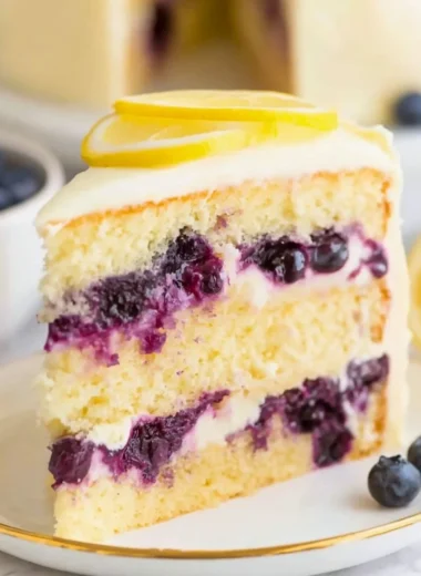 Delicious lemon blueberry cake topped with fresh blueberries and lemon zest