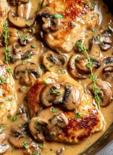 Skillet chicken with mushroom wine sauce served on a plate
