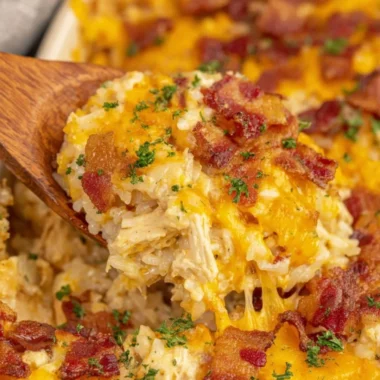 Bowl of slow cooker crack chicken and rice served with garnishments