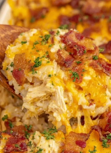 Bowl of slow cooker crack chicken and rice served with garnishments