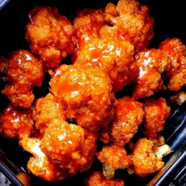 Spicy air fryer Buffalo cauliflower bites served with dipping sauce