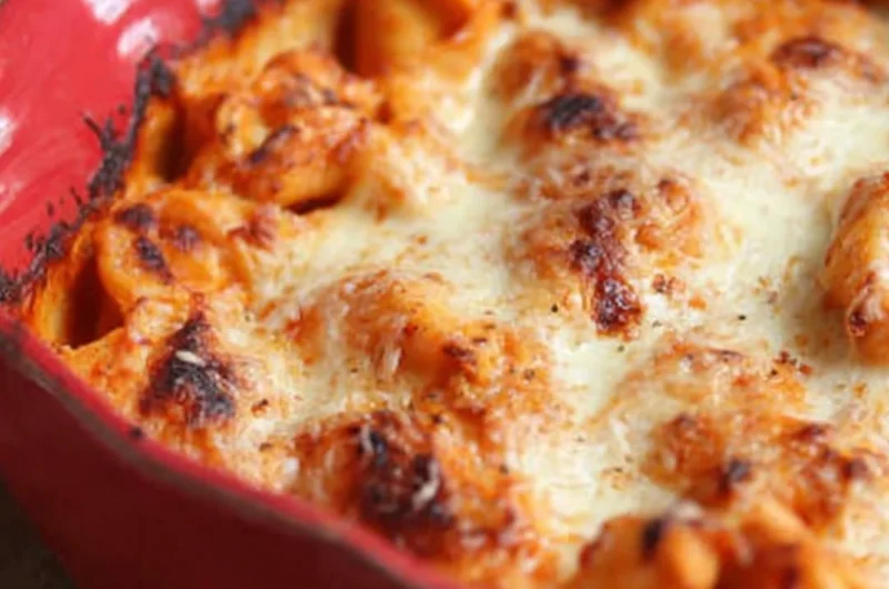 Baked Tortellini with cheese and sauce in a casserole dish