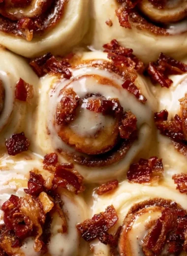 Delicious Bourbon Maple Bacon Cinnamon Rolls topped with creamy glaze