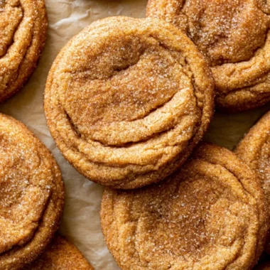 Chewy Pumpkin Snickerdoodle Cookies on a white plate with cinnamon sprinkles